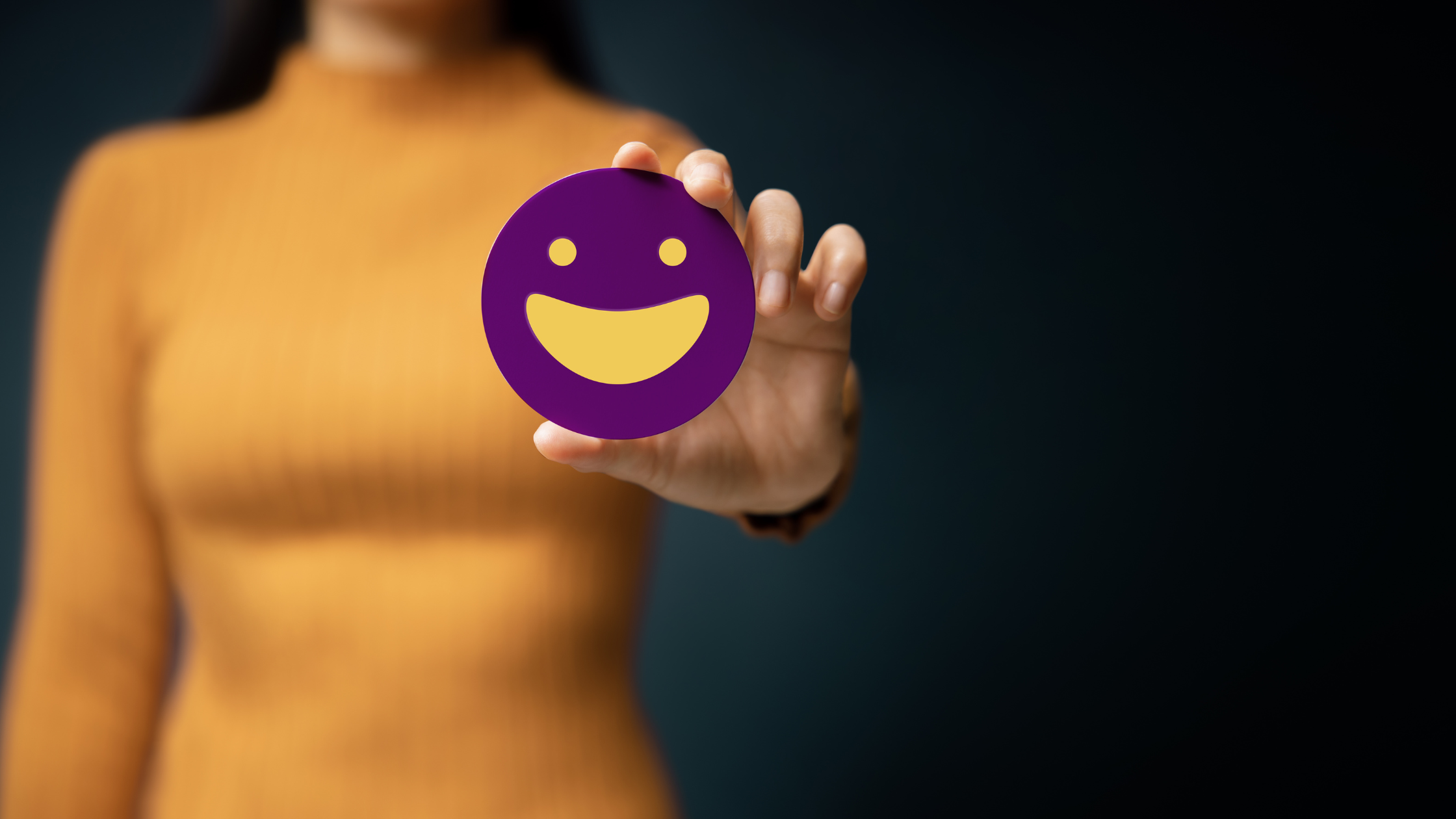 a girl with smiley emoji in hand